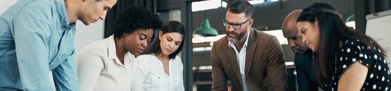 Employees standing at table