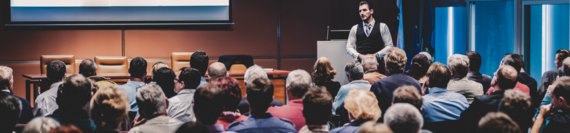 A speaker giving a speech to an audience.