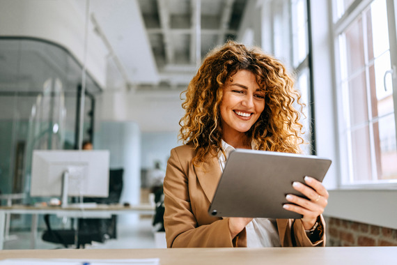 Woman smiling looking at tablet