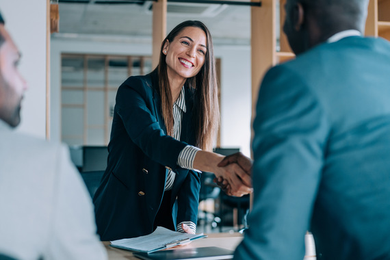 Woman shaking hands with person