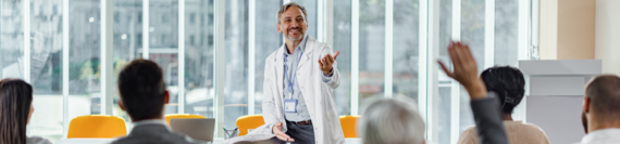 A doctor answering questions from an audience.