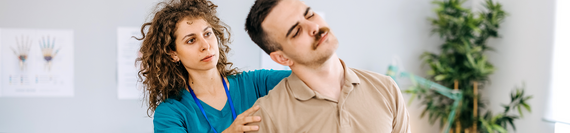 A medical professional examining a patient's back.