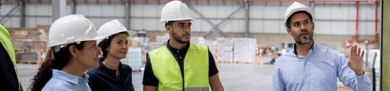 employees with hard hats having a discussion