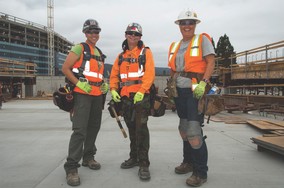 Three construction workers standing