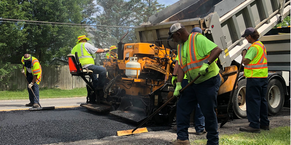 Public service workers re-paving a street