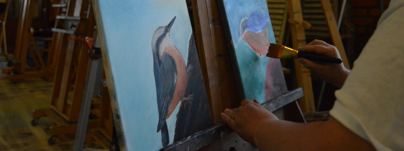 Hands painting a canvas