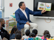 Mayor Andrew Ginther reads a book to a group of children