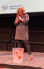 Director Wente has her gloves on and is staring into a bucket of liquid nitrogen, ready to make clouds at COSI.