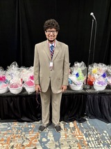 A youth with foster care experience shows off his new suit.