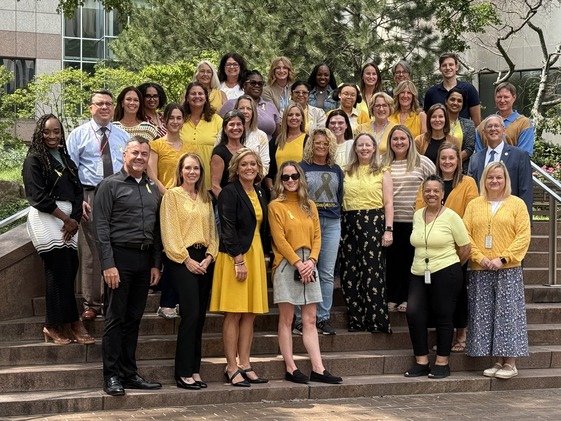 DCY Group Photo with staff wearing gold or yellow.