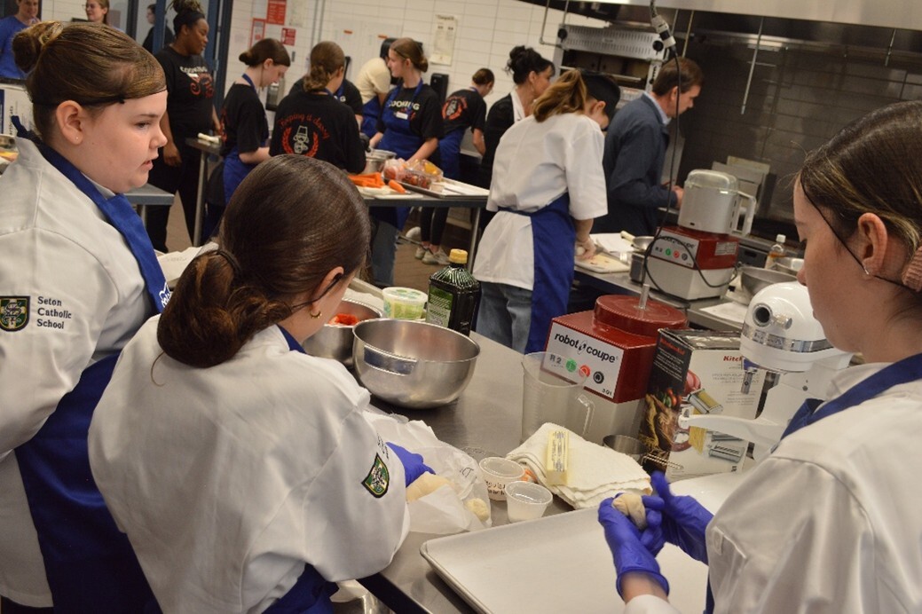 2025 Ohio Grown Student Chef Showcase participants prepare their recipe during the cooking competition.
