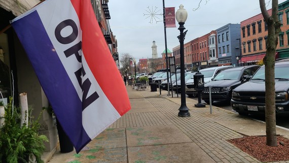 Downtown retail area with wide sidewalk and open banner 