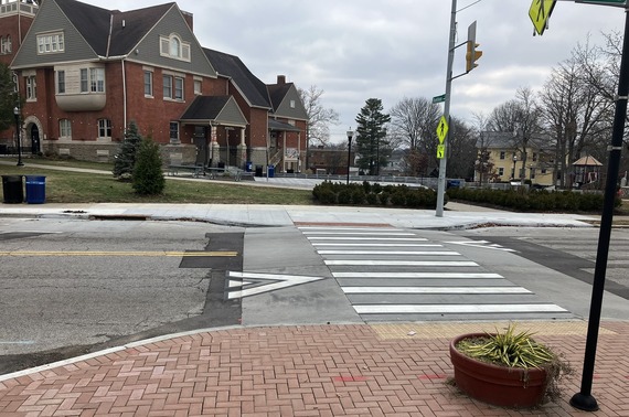 Newly installed raised crosswalk with high visibility pedestrian signage and curb extensions. 