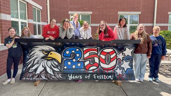 St. Mary's Middle School students pose with their painted plow