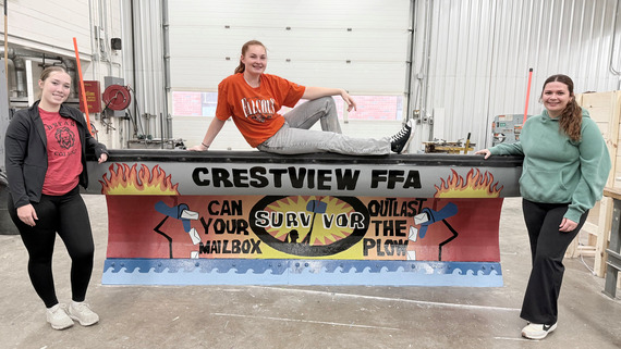 Crestview FFA Chapter students pose with the plow they painted