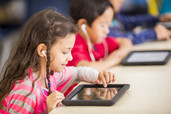 Row of students using tablets.