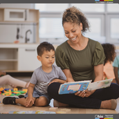 Woman reading to a young child in a classroom. 