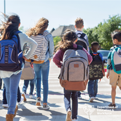 Students walking in a group with backpacks.