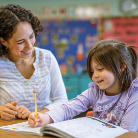 Teacher helping student
