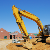 Construction equipment sits outside a school building.