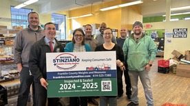Administrators from the food pantry pose with members of the franklin County auditor's office weights and measures team. 