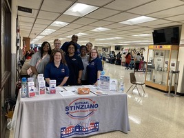 Staff of the Franklin County Auditors office are standing behind a table at a welcoming area at the 2023 Affordable Housing Resource Fair. 