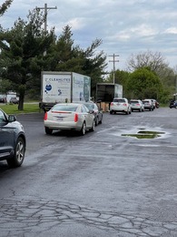 Cars in line waiting to unload documents for the Shred Hunger drive in St. Stephen's parking lot. 