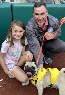 Auditor Stinziano stands with a puppy from the Franklin Count Dog Shelter at Puppypalooza 2023. 