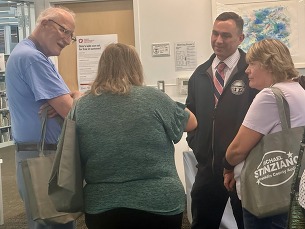 Auditor Stinziano speaks with a crowd at a Community Connects event in July. 
