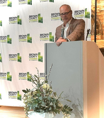 Rep. Bird speaking at a podium at the Brown County Chamber of Commerce Dinner