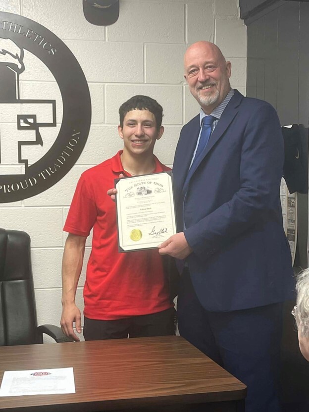 Rep. Click presenting a commendation to a constituent