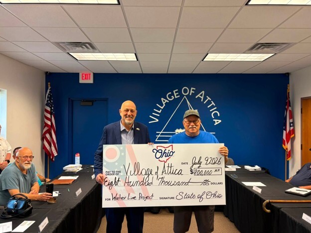 Rep. Click giving a big check to the Village of Attica
