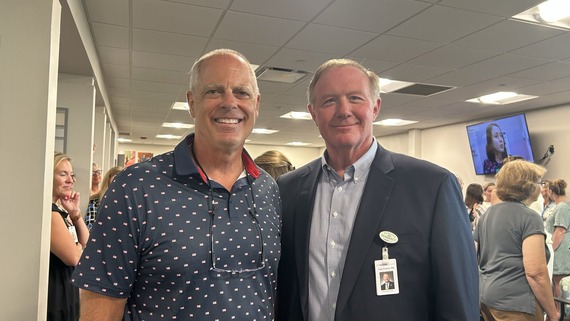 Rep. Bird standing with an event attendee
