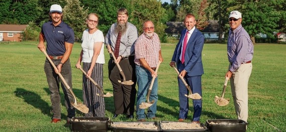 Men standing with shovels