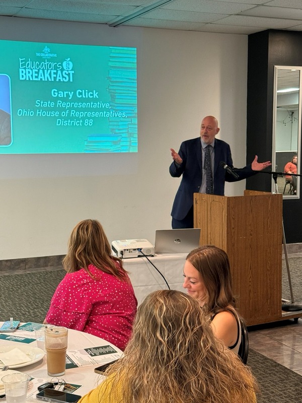 Click at a podium with educators