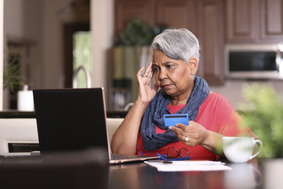 Picture of lady looking shocked on computer