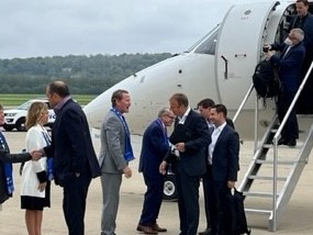 Governor DeWine and Lt. Governor Husted greet members of FIFA as they exit the plane in Cincinnati.