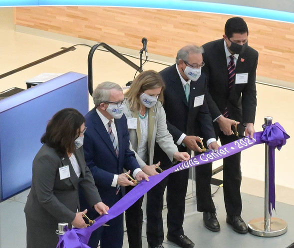 Governor DeWine cuts the ribbon with AES US Smart Operations team members.