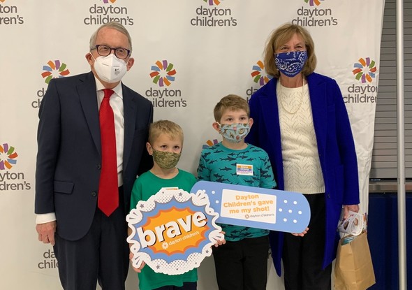 Governor DeWine and First Lady Fran DeWine pose with two children who received their COVID-19 vaccinations at the University of Dayton.