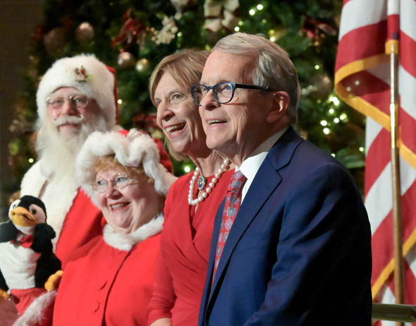 Governor DeWine and First Lady DeWine stand alongside Santa and Mrs. Claus after they lit the Statehouse Christmas tree.