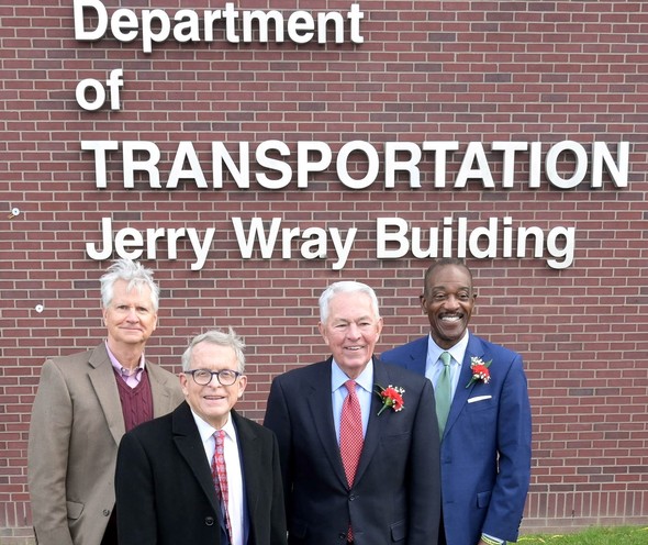 Governor DeWine stands in front of the new ODOT Headquarters signage.