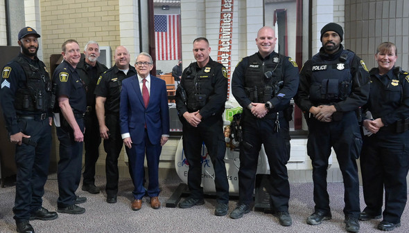 Governor DeWine stands alongside members of the Euclid Police Department after a press conference.