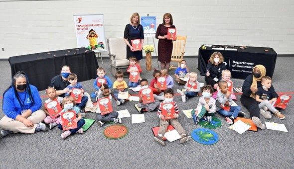 First Lady DeWine and Director of Commerce Sherry Maxfield pose with children after the book reading at the YMCA Early Learning Center West.