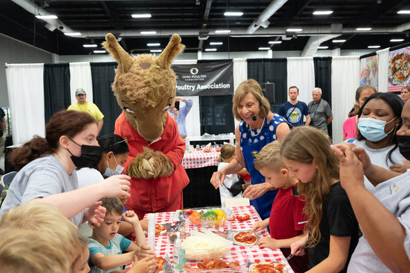 First Lady Fran DeWine helps kids at the Ohio State Fair as they make their very own pizza.