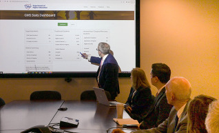 Governor DeWine pointing at a video board during a meeting with the Ohio Department of Higher Education. 