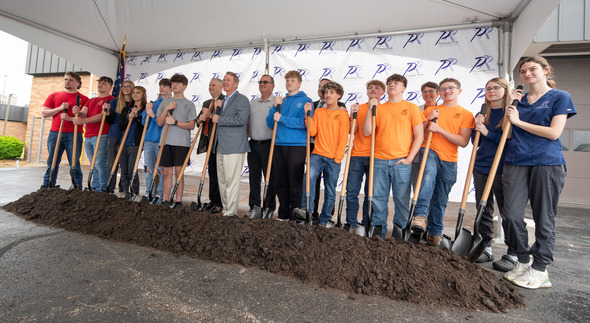 Husted with students holding shovels to break ground