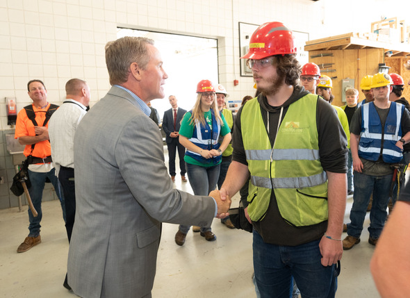 Husted shaking hands with male construction student