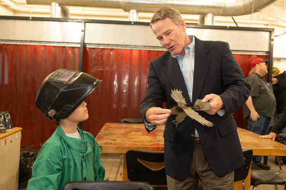 Husted viewing welding project with male student