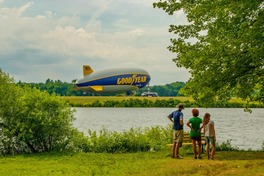 Visitors take in the sight of a Goodyear blimp at Wingfoot Lake