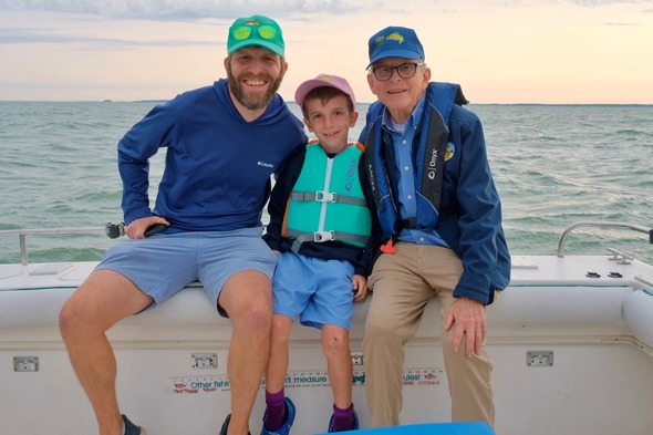 Governor DeWine participates in the Governor's Lake Erie Fish Ohio Day with his son and grandson.